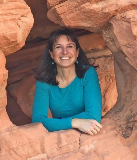 Photo of Jen Newmark framed by red rocks