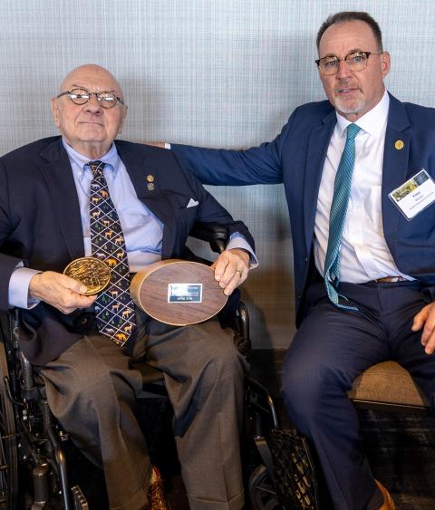 Lowell Baier receiving the 2025 Grinnell Award from Tony Wasley