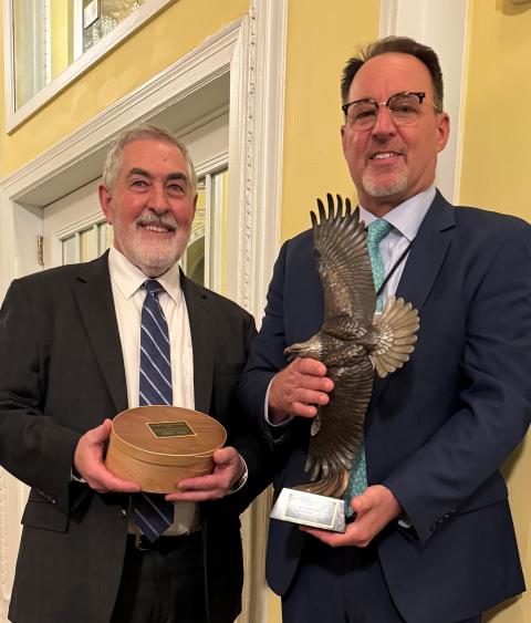 Kenneth Elowe receiving the Grinnell award from Tony Wasley