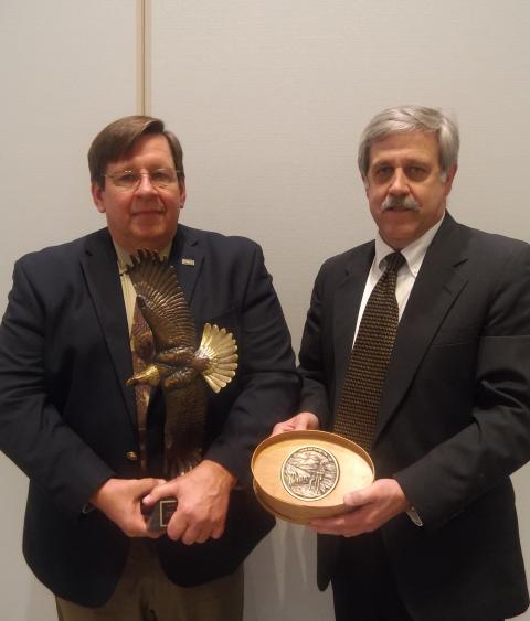 Steve Williams presents Dr. John Fischer with the 2018 Grinnell Award