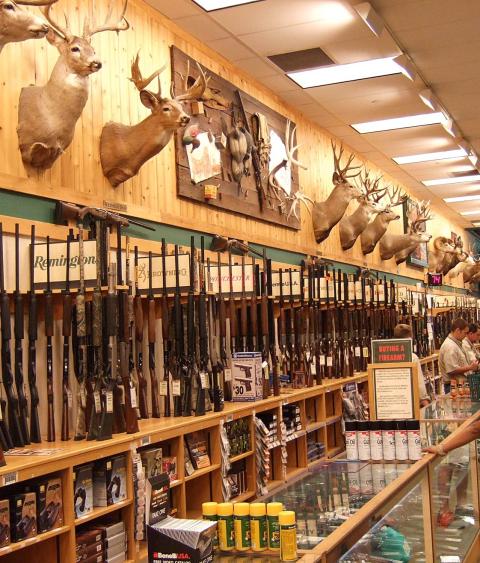 Gun store service desk and customers