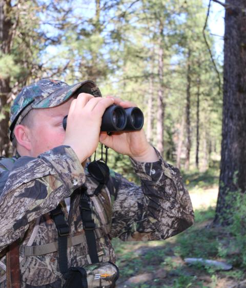 Hunter looking through binoculars