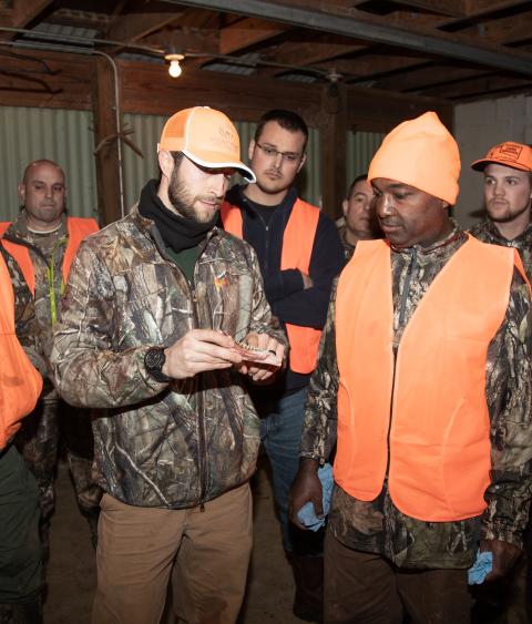 A hunter education instructor teaches class.