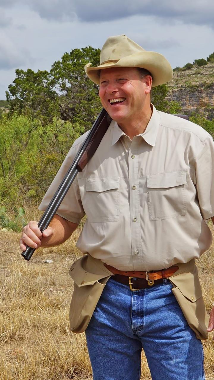 Carter Smith with break action shotgun over his shoulder 