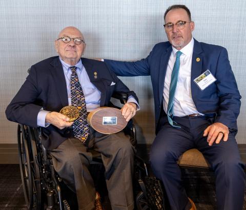 Lowell Baier receiving the 2025 Grinnell Award from Tony Wasley