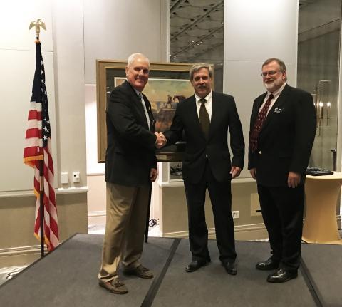 Boone &amp; Crockett Club president Ben Hollingsworth Jr. (L) and stewardship and multiple-use sharing committee co-chair Jimmy Bullock (R) present the Conservation and Stewardship Award to Steve Williams.