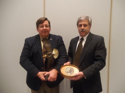 Steve Williams presents Dr. John Fischer with the 2018 Grinnell Award