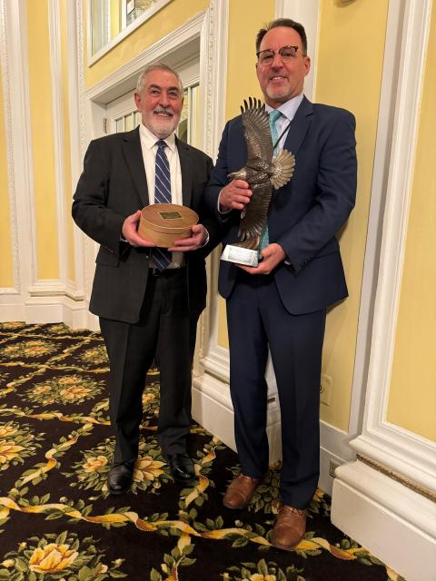 Kenneth Elowe receiving the Grinnell Award from Tony Wasley